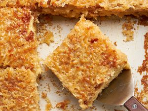 Lazy daisy cake slice on a spatula in a pan with more cake