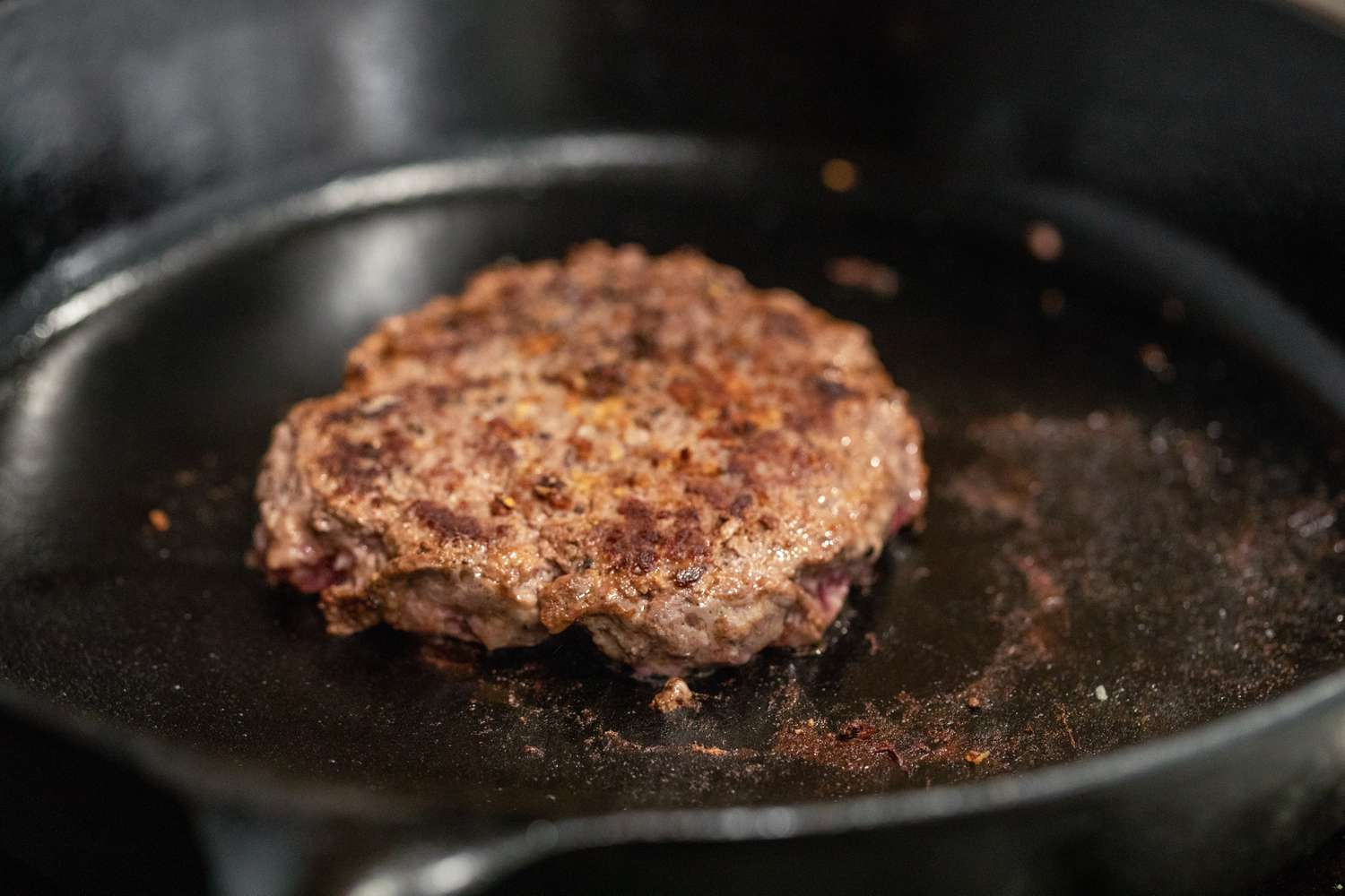 Cooked Burger Patty on the Cast Iron Skillet for How to Cook a Burger on the Stove