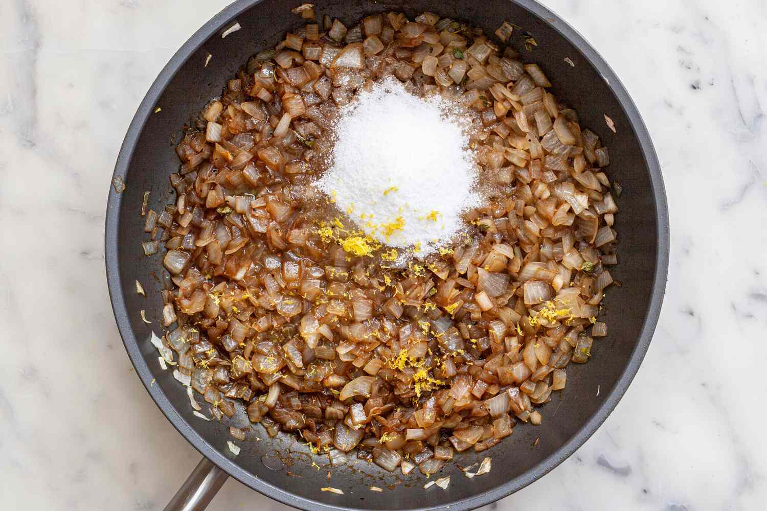 Adding ingredients to the sauteed onions to make balsamic onion jam