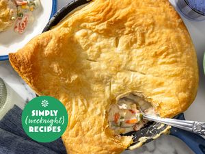 A pot pie with a serving removed plated nearby