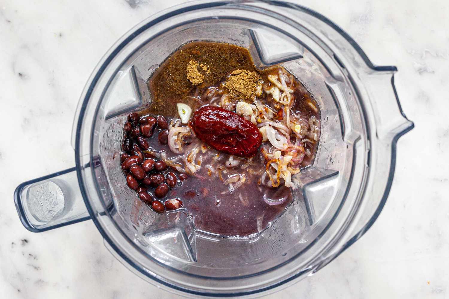 Ingredients in a blender to show how to make Enfrijoladas.