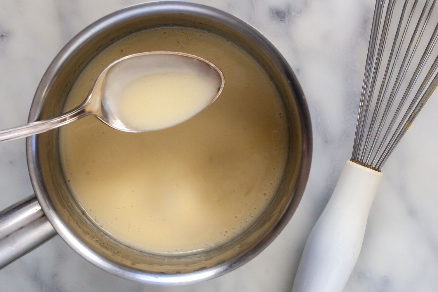 Whisk classic buerre blanc sauce until creamy