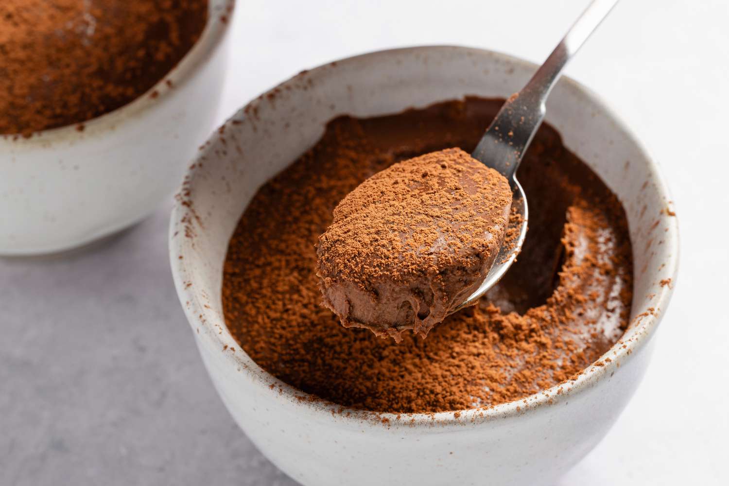 bowl of 2-Ingredient Chocolate Mousse with a spoon full of the mousse hovering above it