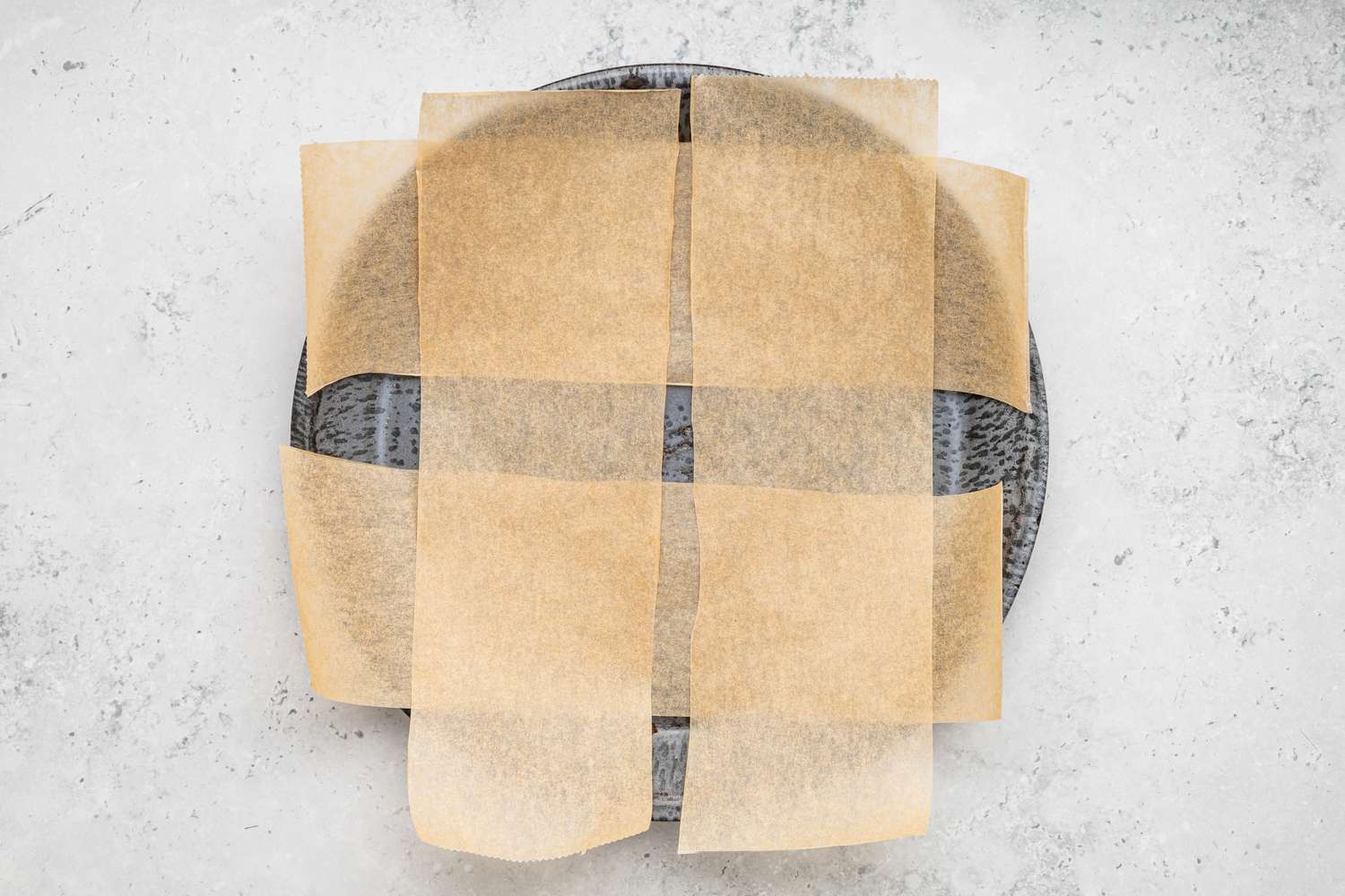 Four Strips of Parchment Paper on a Plate (Crisscrossed) for Chocolate Cake Recipe