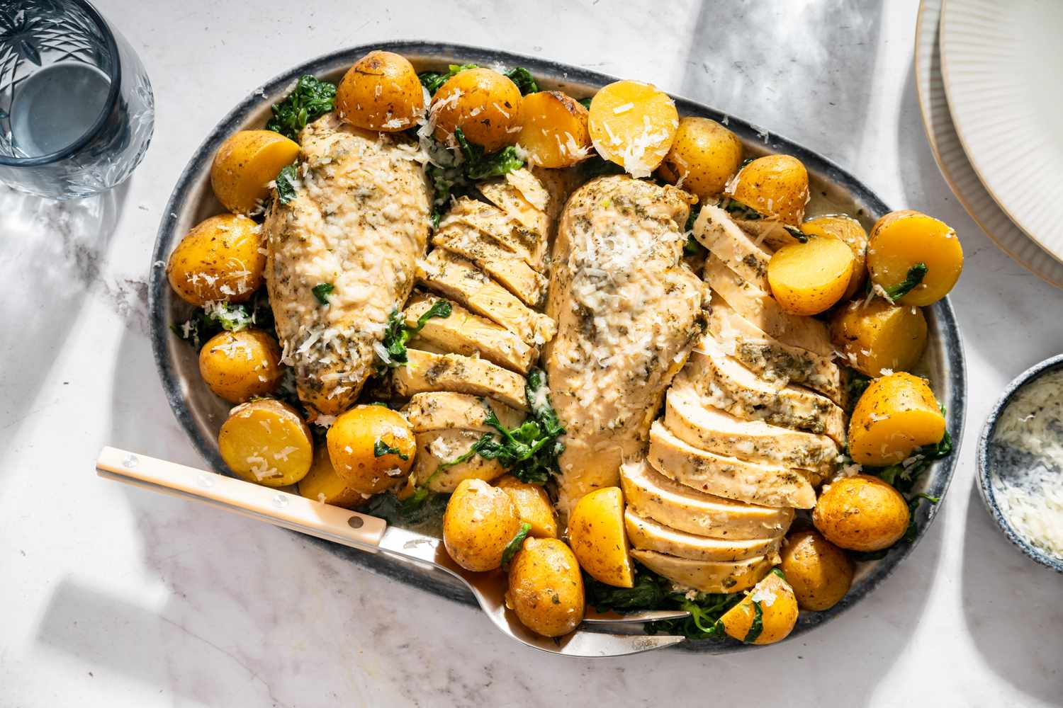 Plated chicken and potatoes garnished with herbs prepared meal centerpiece