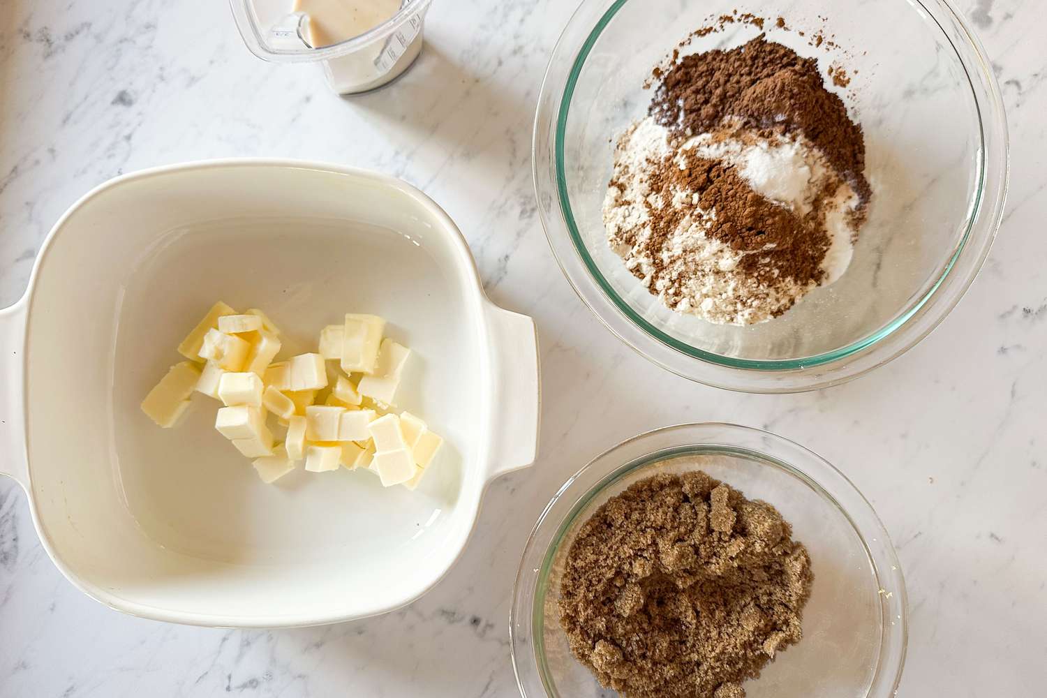ingredients in various bowls for Samantha Seneviratne's 10-Minute Microwave Chocolate Pudding Cake