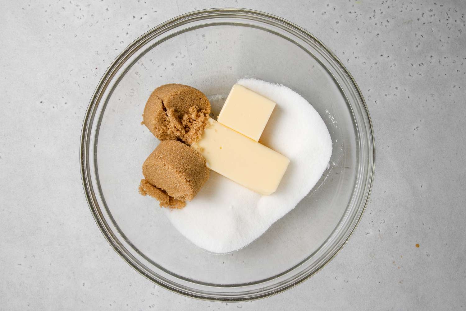 Butter and sugars in a bowl to make chewy double chocolate cookies.