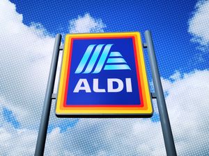 Aldi supermarket sign against a cloudy sky