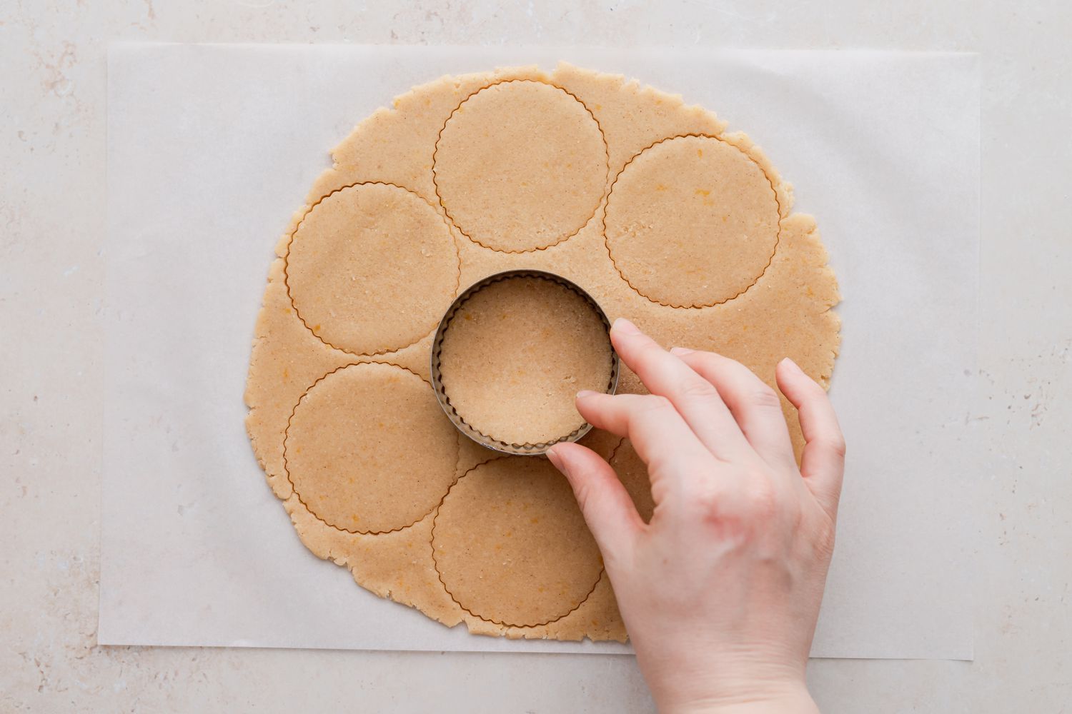 Cutting out circles of dough to make classic linzer cookies.