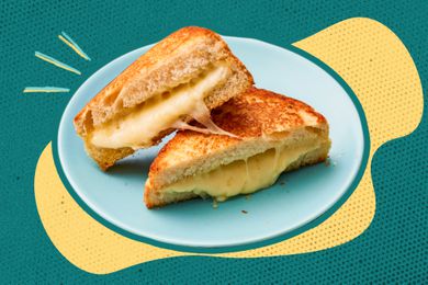 Image of a grilled cheese sandwich on a plate with yellow and blue illustrations in the background