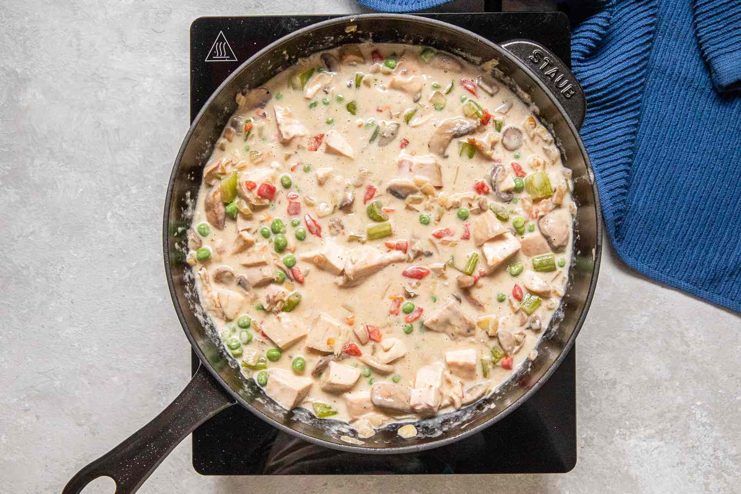 Chicken and the rest of the vegetables added to the cast iron skillet for chicken a la king recipe
