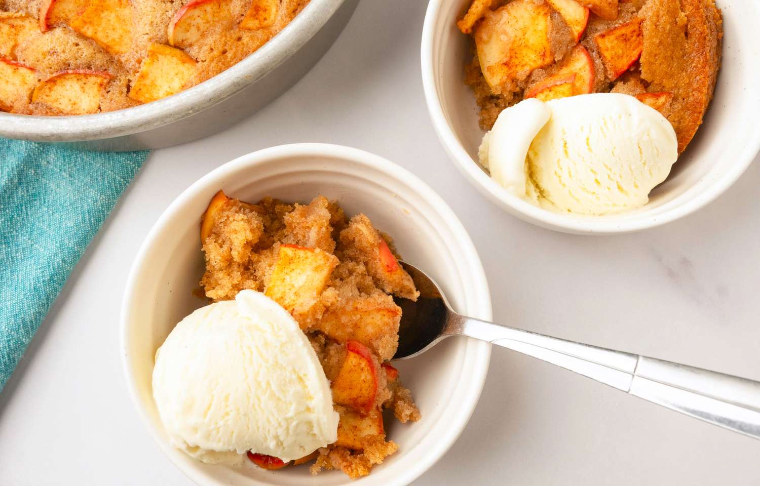 An apple dessert served in bowls with scoops of ice cream