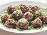 Stuffed mushroom caps on an appetizer tray