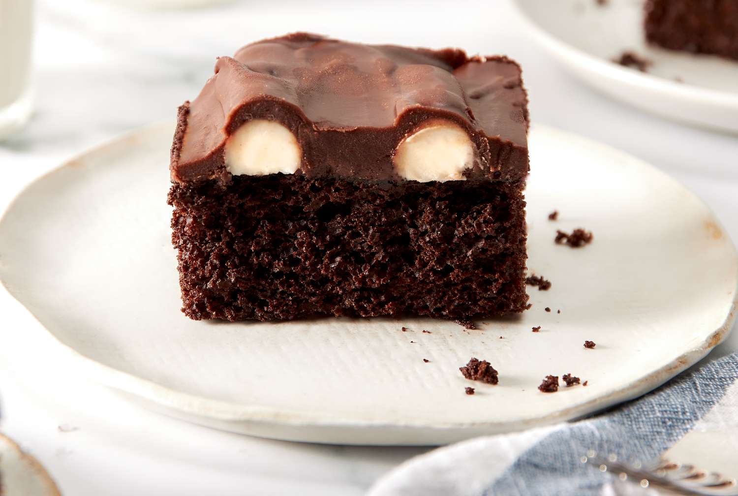 Bumpy cake on a small plate with cross-section facing forward