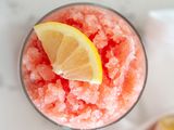 Top view of a watermelon granita toped with a lemon slice.