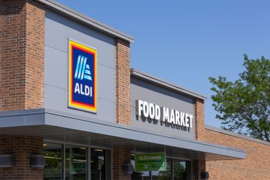 Exterior of an Aldi Food Market store entrance with a visible sign displaying the stores name