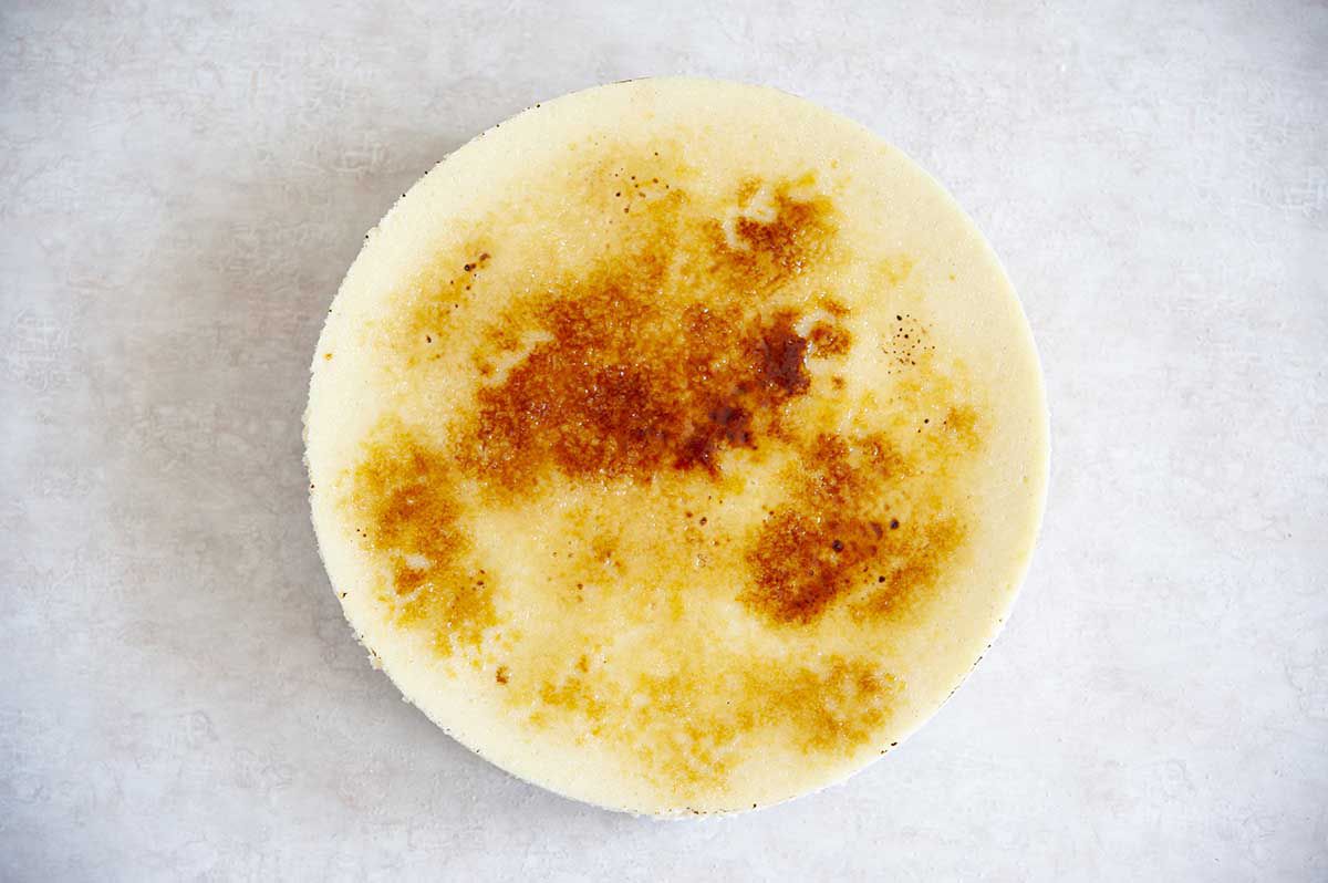 A Vanilla Bean Cheesecake with a brittle sugar creme brulee topping.