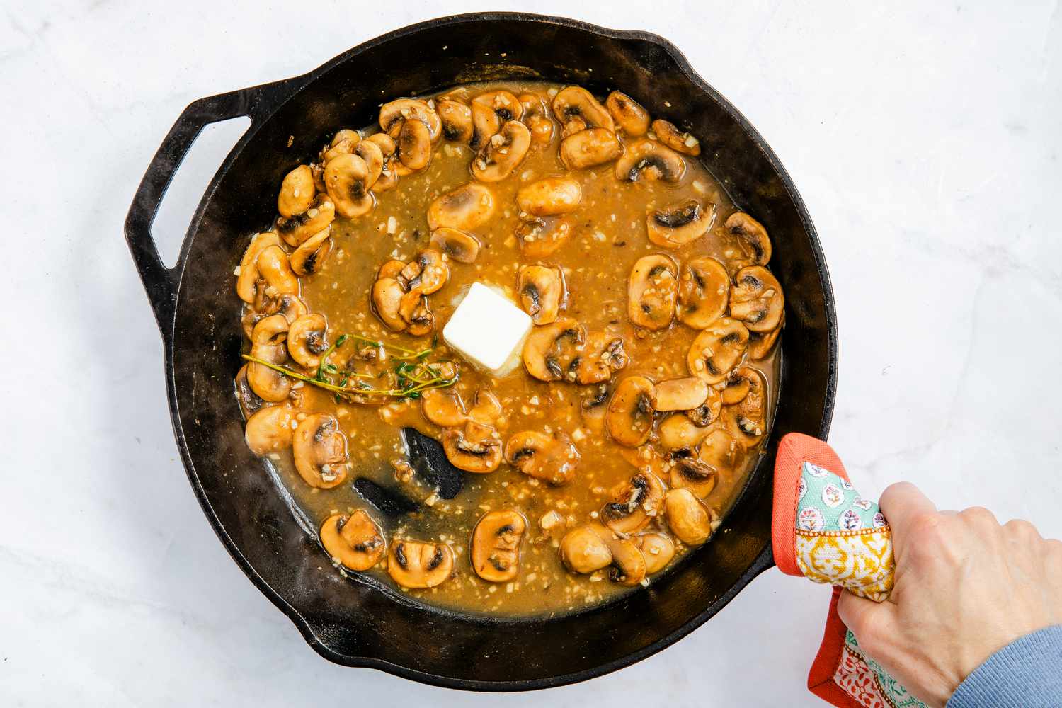 butter added to the cast iron skillet for chicken marsala recipe