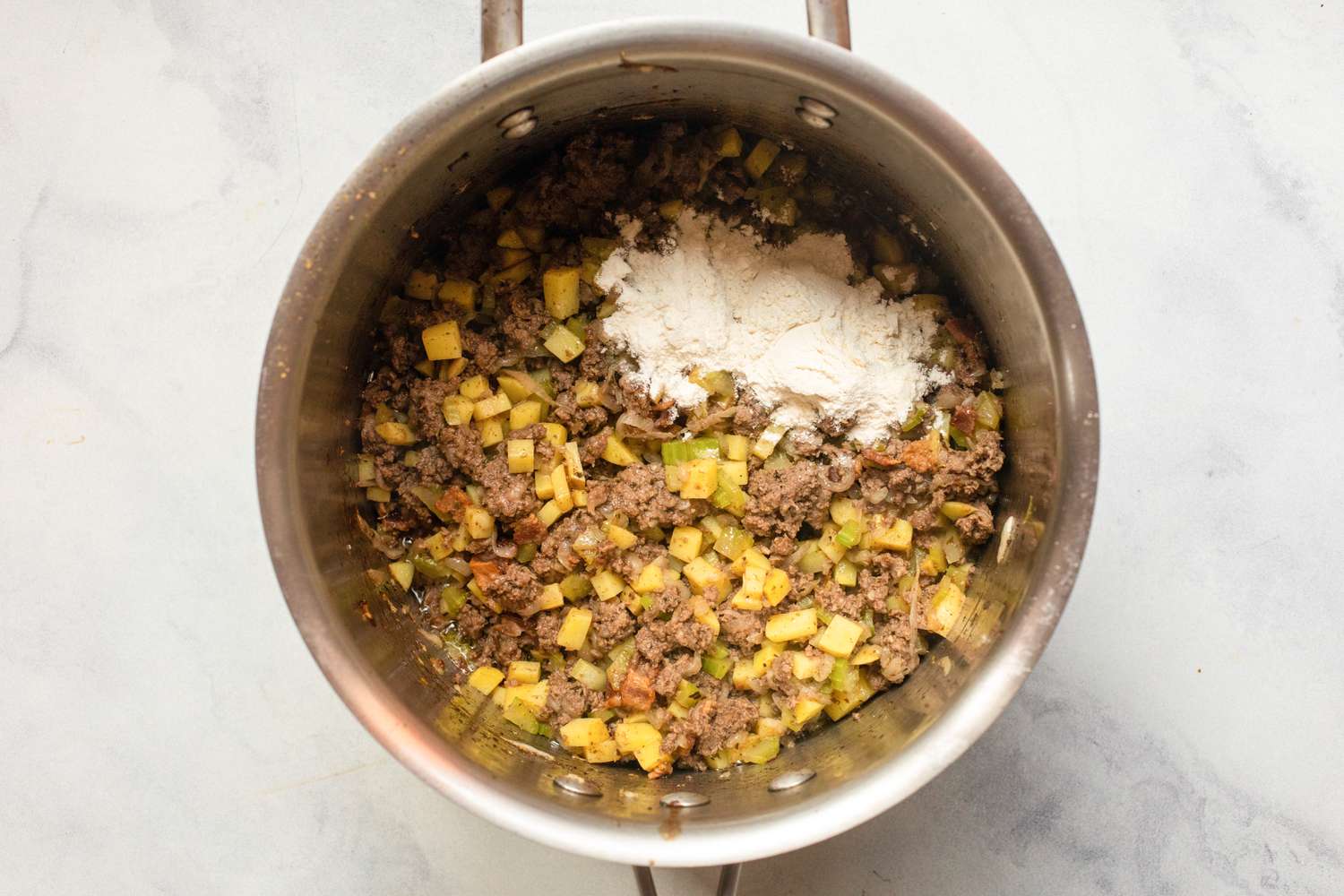 Add the flour to thicken the soup.