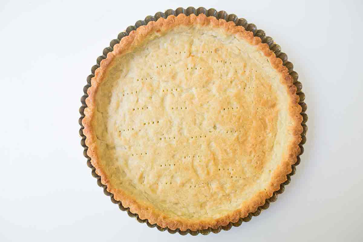 A tart pan with a blind baked tart crust