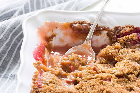 Rhubarb Crumble on a white dish with a spoon