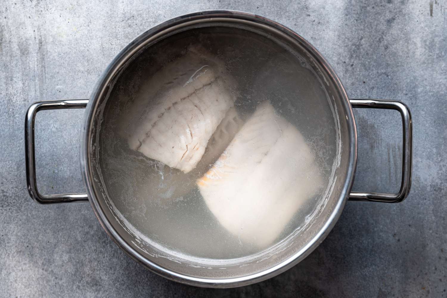 Poached cod in a pot 
