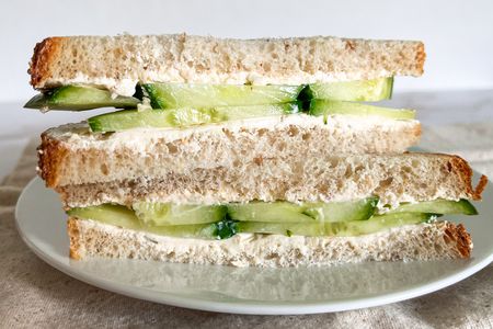 1-minute cucumber sandwich sliced in half and on a plate