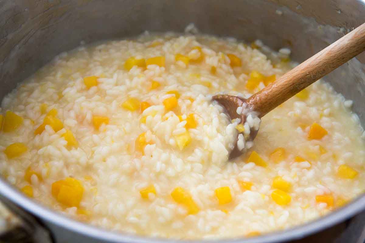 stirring risotto with a wooden spoon