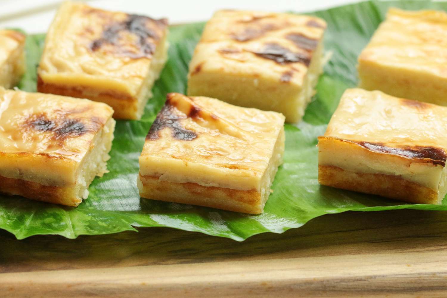 Cassava Cake Slices on a Banana Leaf Covered Wooden Tray
