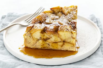 Slow Cooker French Toast Casserole Recipe - slice french toast casserole on plate with syrup and fork