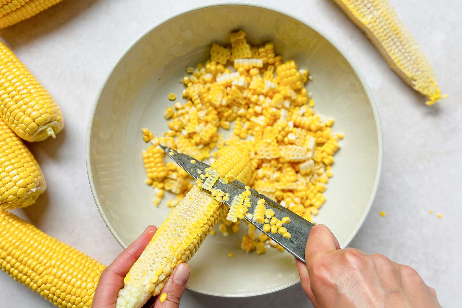 Corn Cut Off Cob into a Bowl Using a Knife for Esquites 