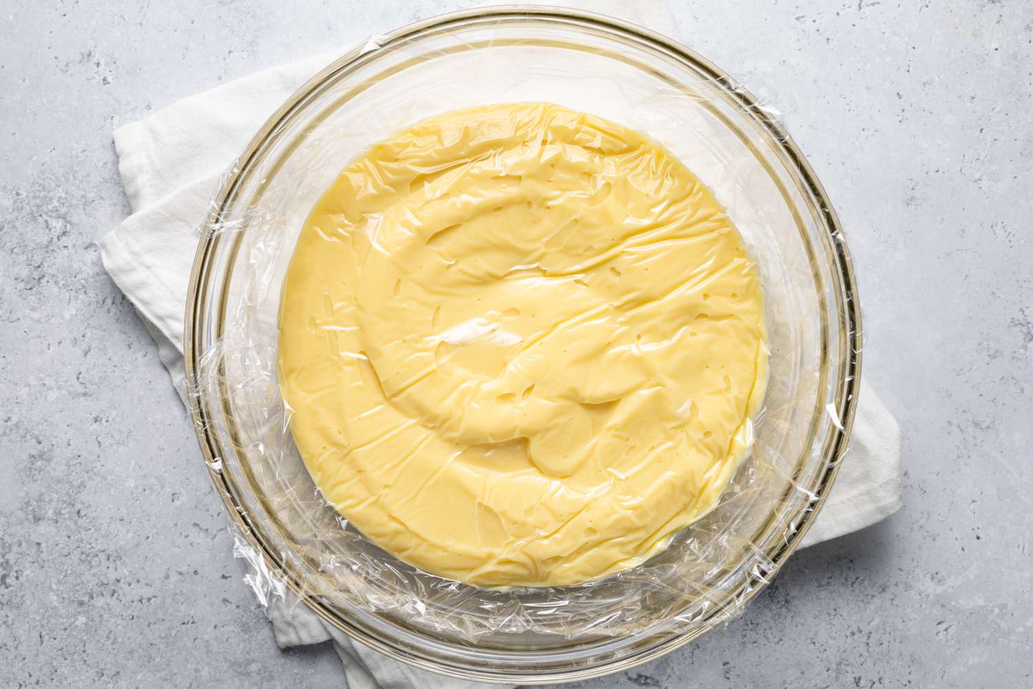 Vanilla Custard in a Bowl Covered in Plastic Wrap