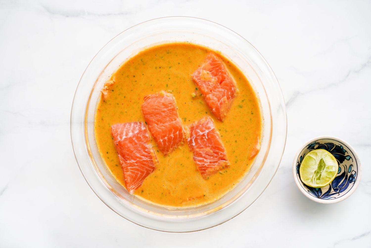 Salmon Filets Added to Bowl of Microwave Red Curry Poached Salmon Ingredients