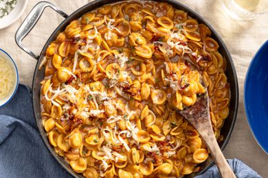 French onion pasta in a pot at a table