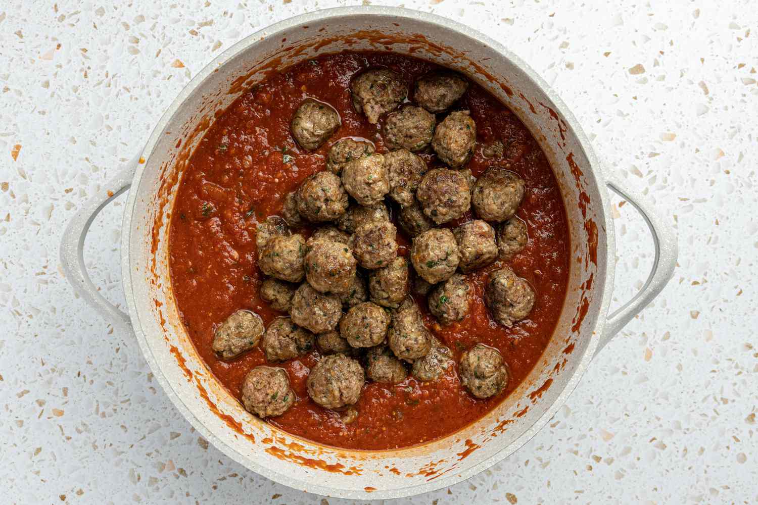 Meatballs Added to Pot of Sauce