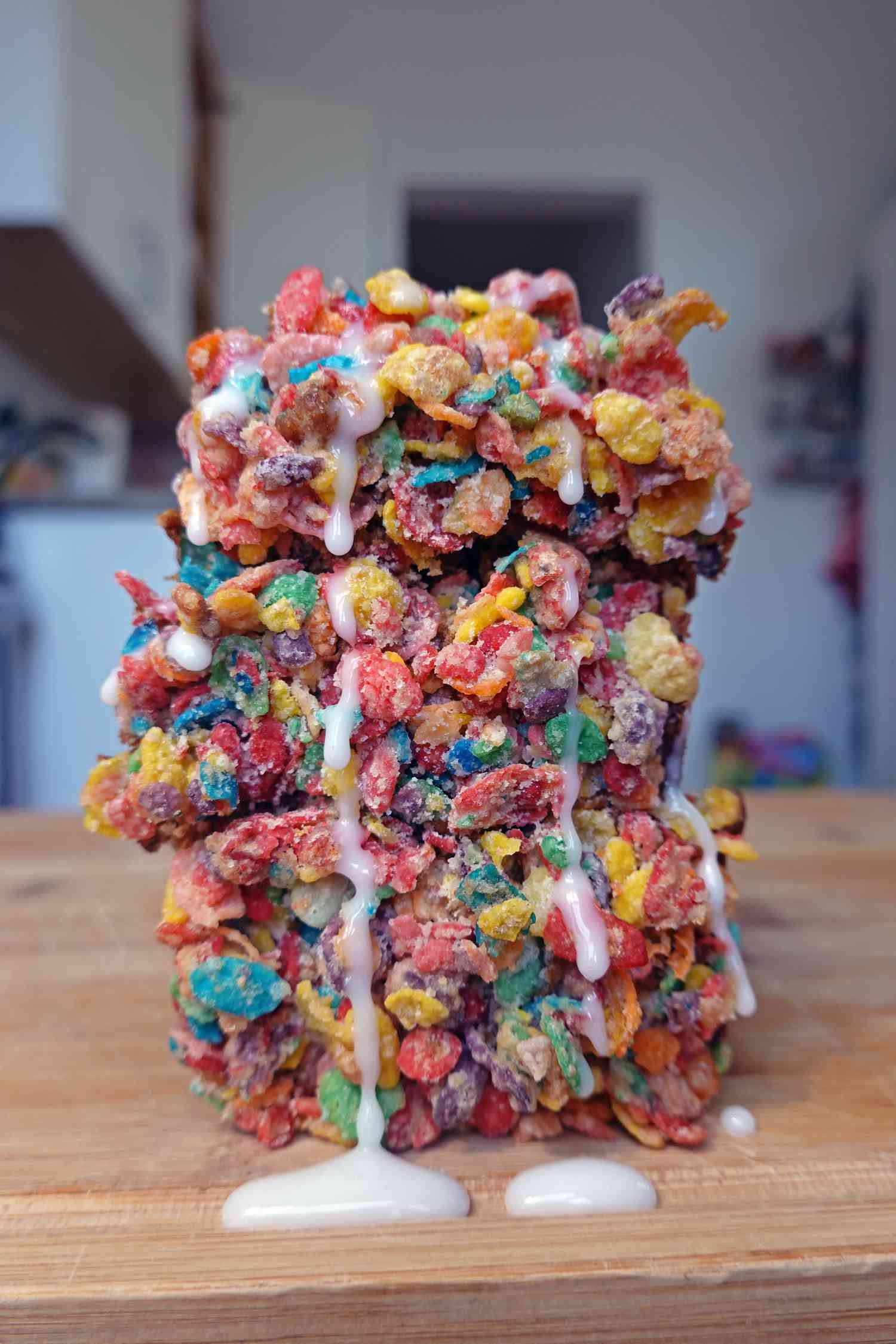 Stacked slices of banana bread covered in fruity pebbles 
