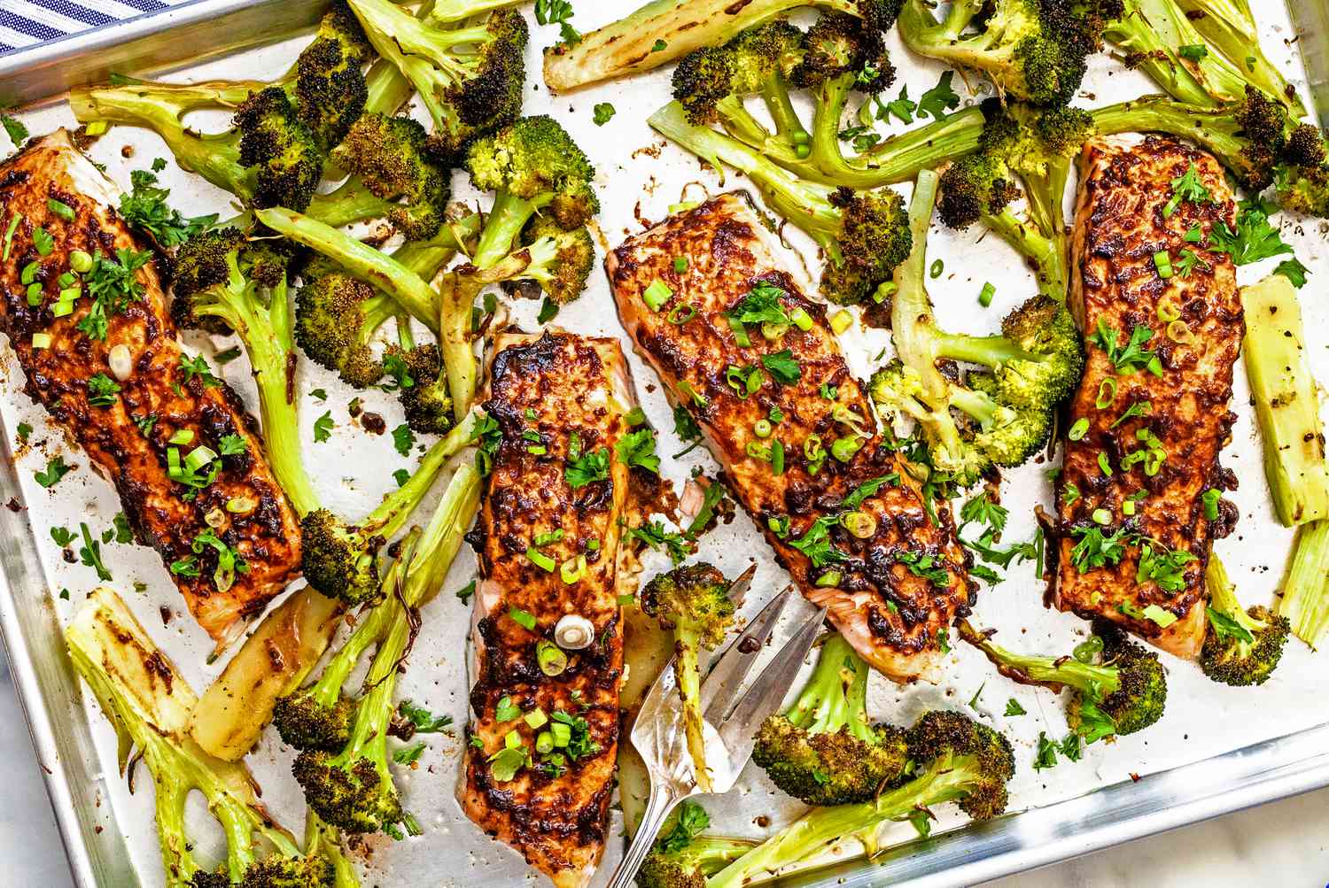 Miso butter roasted salmon and broccoli on a sheet tray
