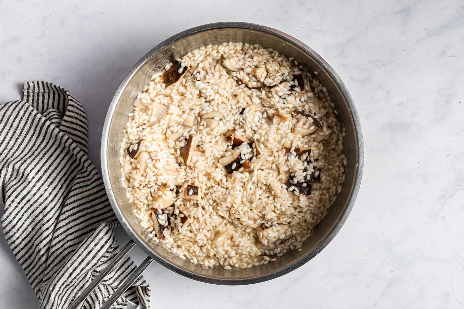 Overhead view of a pot of mushroom risotto.