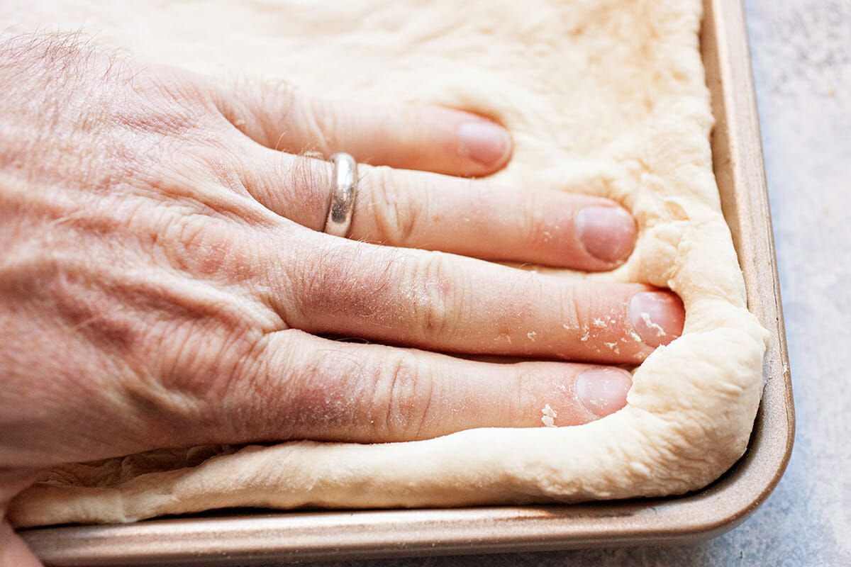 Sheet Pan Pizza with Pepperoni press the dough into the pan