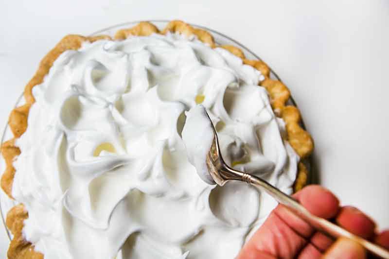 Adding meringue topping to lemon meringue pie