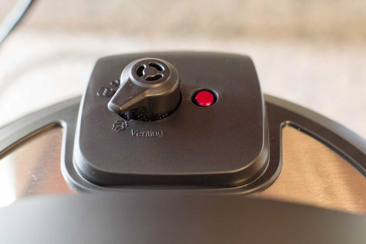 View of the venting knob on a pressure cooker to make IP chicken.