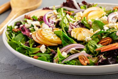 Winter salad with apple, red onion, pecans, cranberries, and spring mix