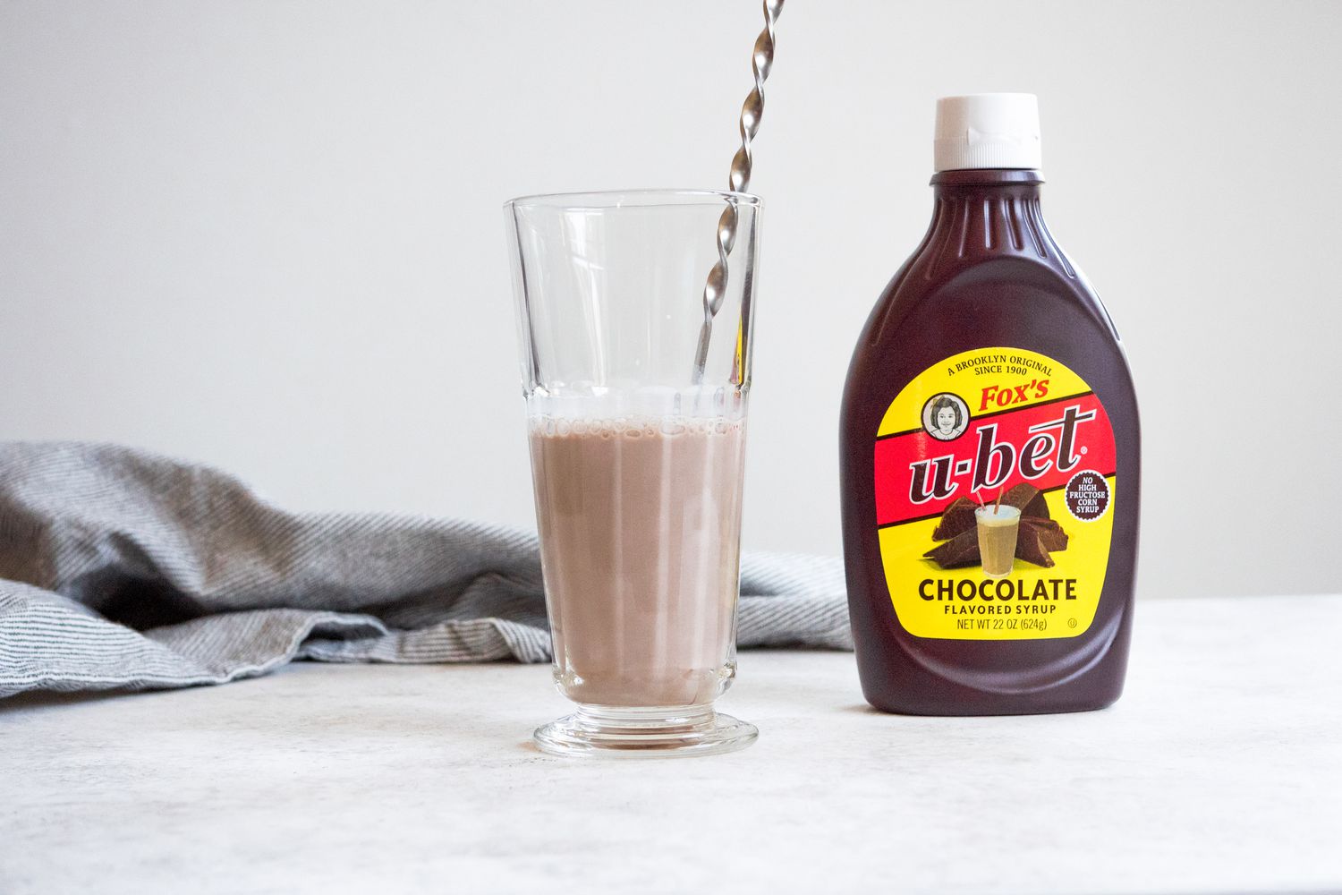 Classic Egg Cream with Bartender Mixing Spoon in Glass 