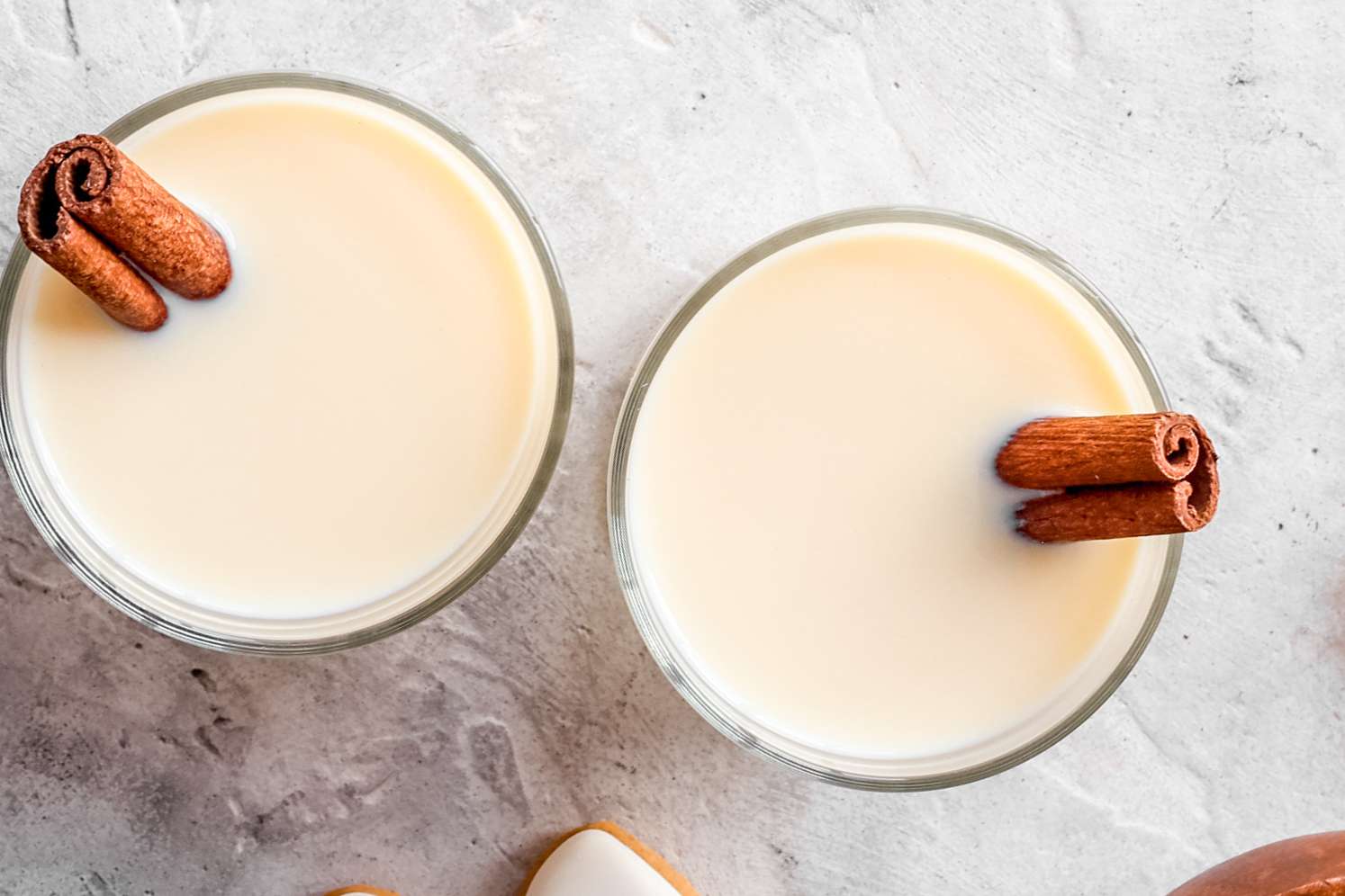An overhead view of two glasses with eggnong