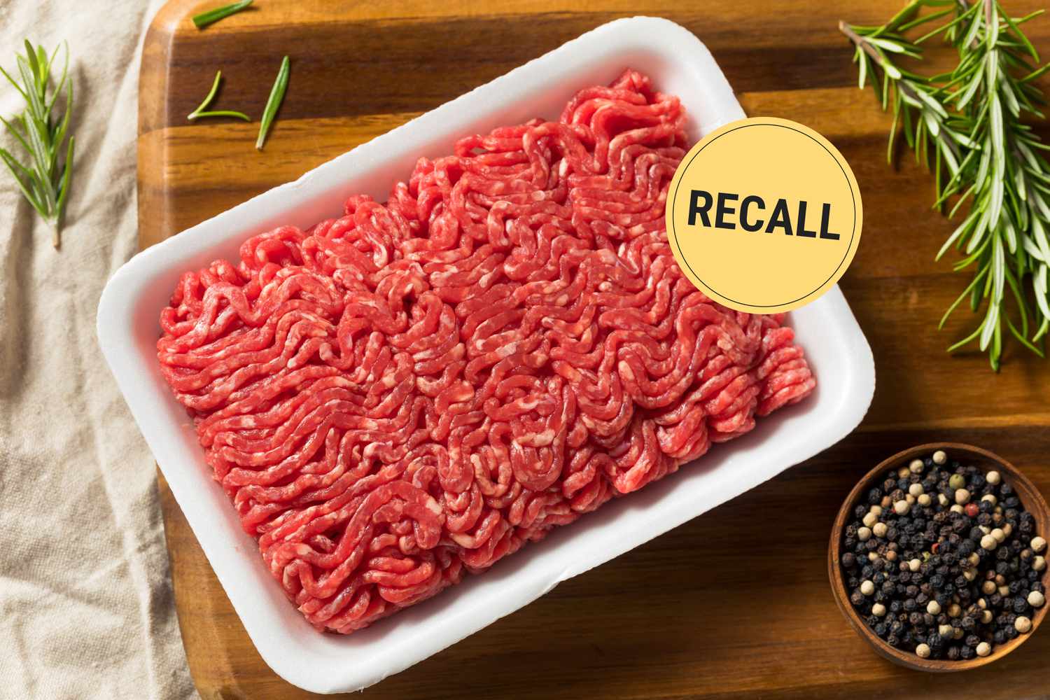 Container of raw ground beef with text overlay "Recall"