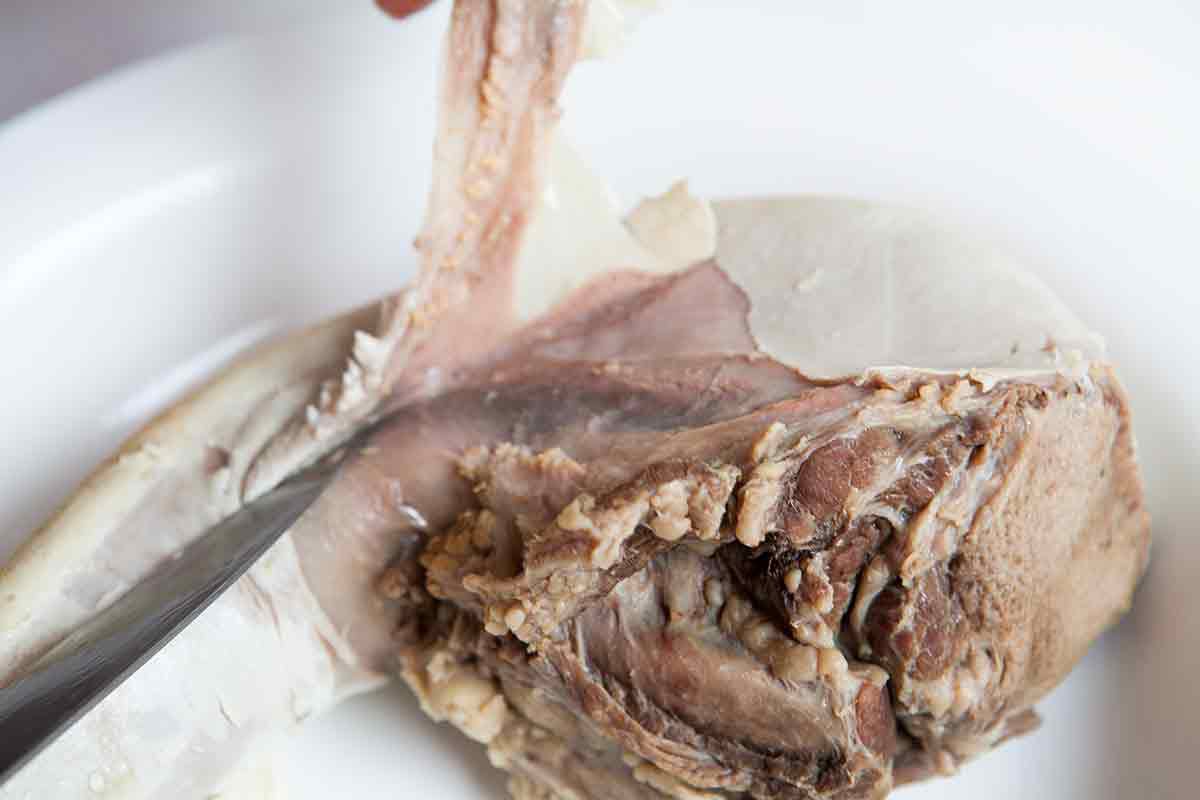 remove light part of skin covering beef tongue for beef tongue tacos