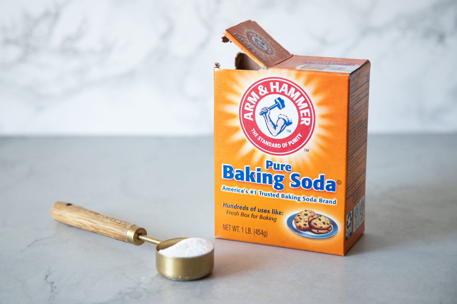 Box of Baking Soda and a Measuring Spoon Full of Baking Soda
