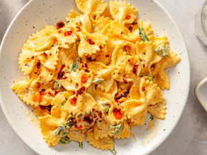 A plate of farfalle pasta with chili crisp seasoning and a creamy sauce