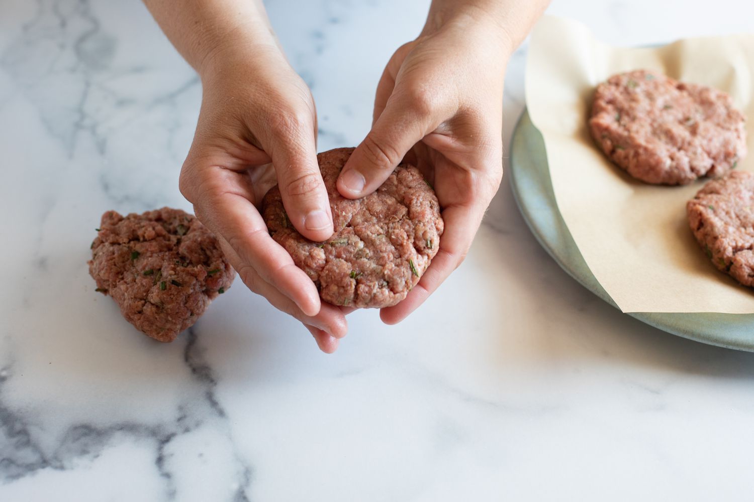 Forming hamburger patties to make a famous burger.