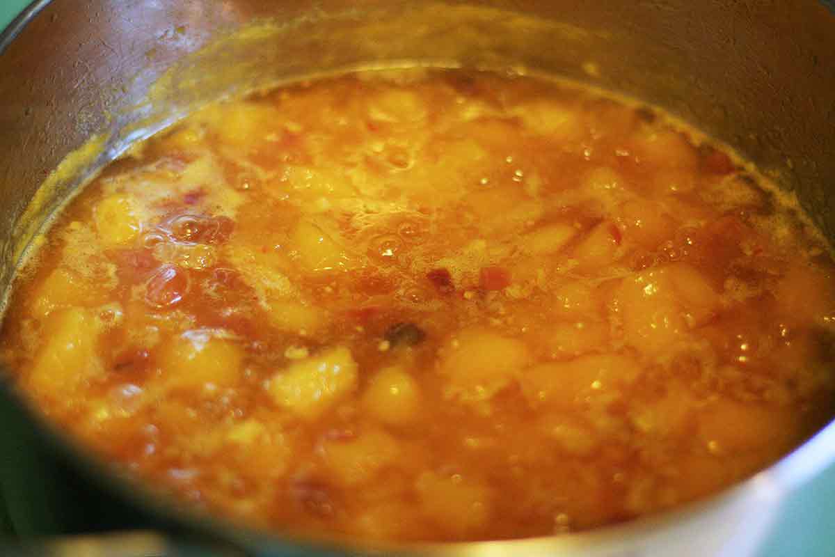 A simmering pot of mango chutney